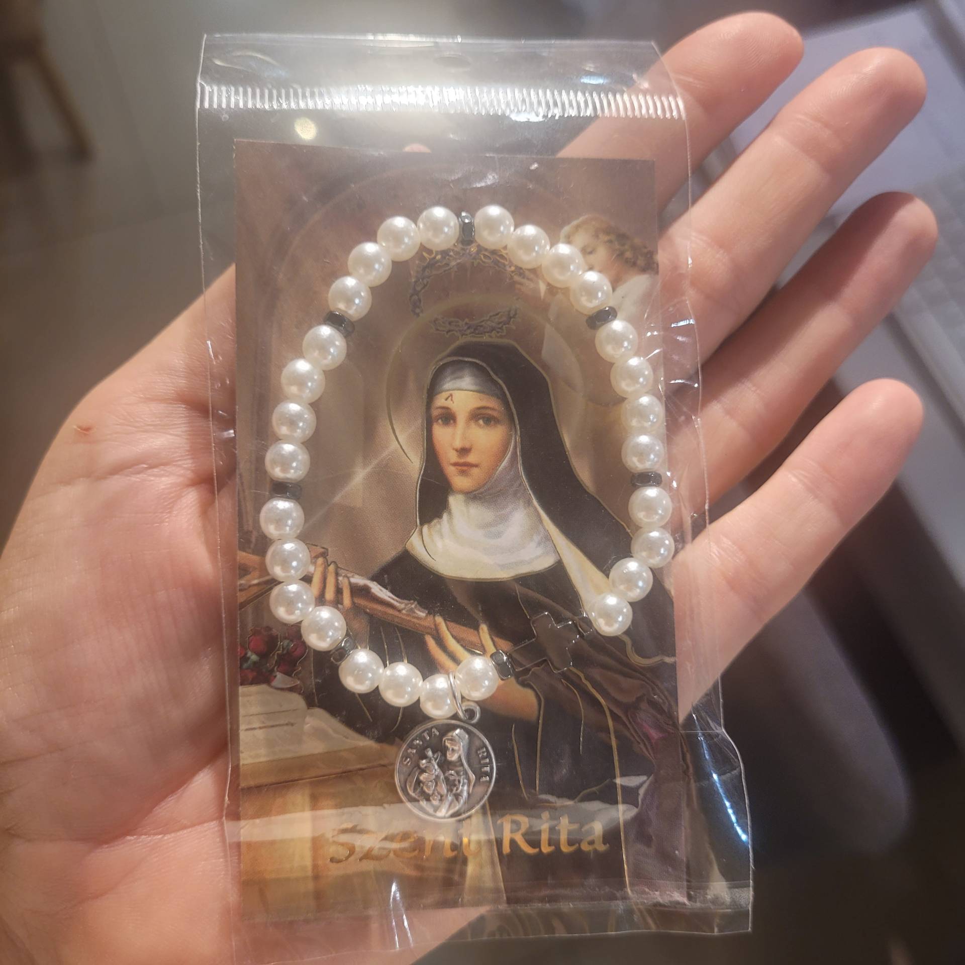 Szent Rita Karkötő Hematit keresztel+ szentkép imával 
